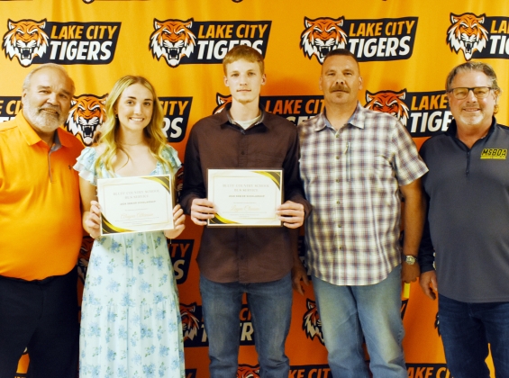 Bluff Country School Bus Service Scholarship, $500 each. From left are presenter Jeff Prigge, recipients Alayna Atkinson and Layne Clausen, presenter Justin Clausen, and presenter Doug Grisim.