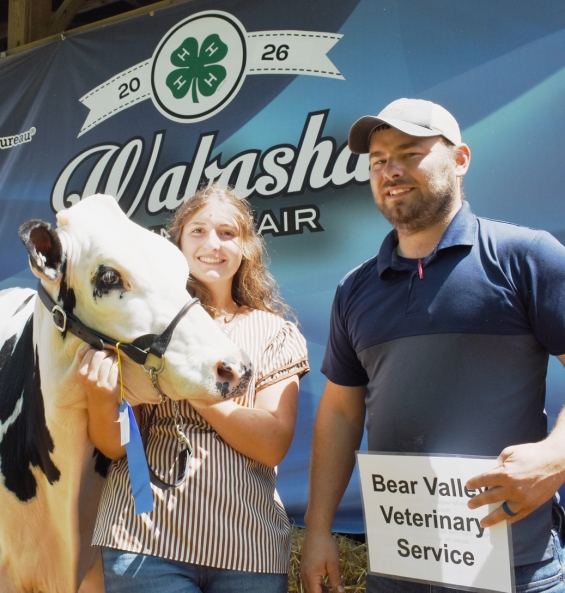 Emma Dunn of the Gillford Golden Gophers with a representative of buyer Bear Valley Vet Service.
