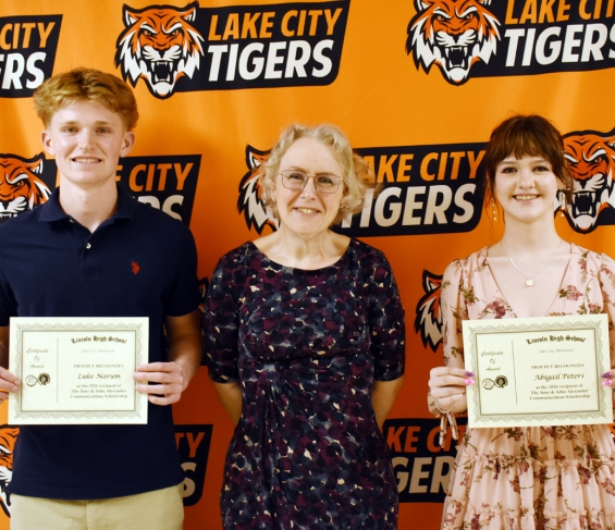 The June and John Alexander Communications, $2,239 each. From left: recipient Luke Narum, presenter Dr. Candance Wait, and recipient Abigail Peters.