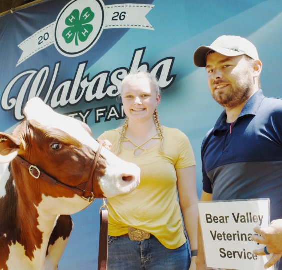 Lily Dittfach of the Gillford Golden Gophers with a representative of buyer Bear Valley Vet Service.