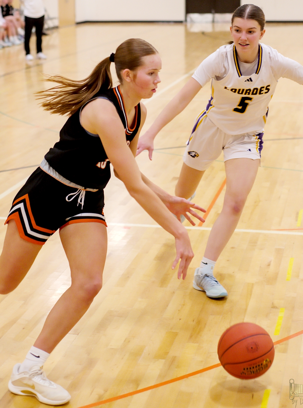 Junior forward Dorothy Halder drives around a Lourdes defender on Thursday night. -Photo by Dave Ender